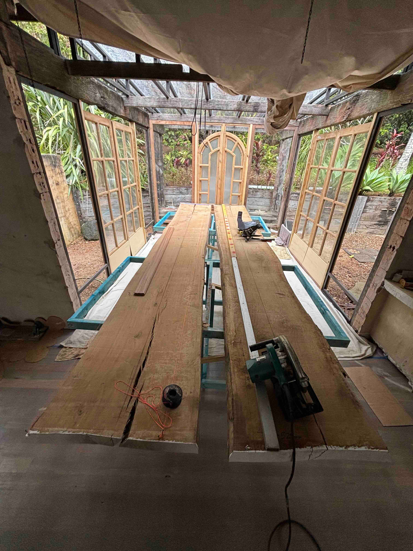 Raw hardwood slabs resting on a workbench before being docked and dressed